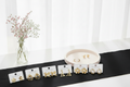 Stainless steel earrings on display cards with pink ceramic tray