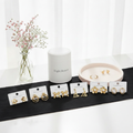 Stainless steel earrings on display cards with Eight Beauty pouch and pink ceramic tray